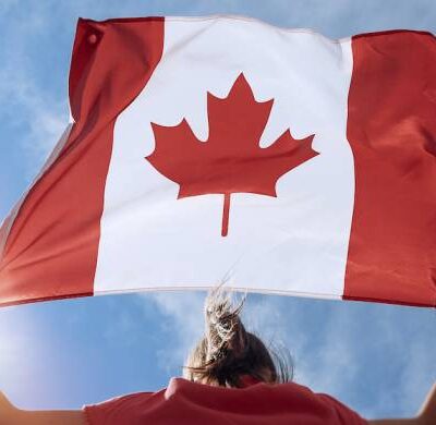 Girl Showing Canada Flag - Canada Immigration Consultant
